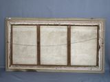 an old window frame with a window pane on the outside