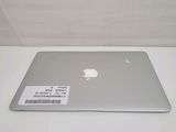 a silver apple laptop sitting on a white table