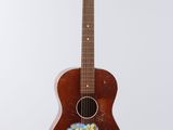 an image of a guitar hanging from a string on a wall