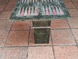 a green marble bench sitting on a tiled floor