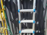two ladders are sitting next to each other in front of a building