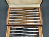 an image of a set of six silver plated fountain pens in a wooden case