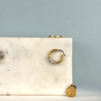 une boîte en marbre blanc ornée de deux anneaux en or