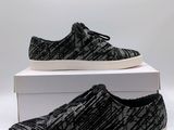 a pair of black and white sneakers sitting on top of a box
