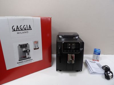 a black coffee machine sitting next to a red box