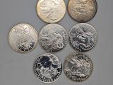six different british coins sitting on top of each other on a table