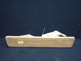 a statue of a person laying in a wooden box
