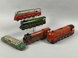 four different types of toy trains on a white surface