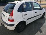 a small white car parked in a parking lot