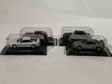 three toy cars in a display case on a white surface
