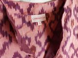 the shirt is pink and purple with a pattern on it