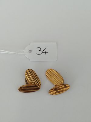 a pair of gold heart shaped earrings with a price tag