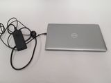 a laptop and a charger sitting on a table