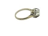 a close up of a diamond ring on a white background