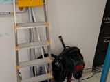 a ladder that is leaning against a wall in a room