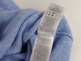 the label on a blue sweater is attached to a pair of socks