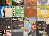 many different types of vinyl records on the wall