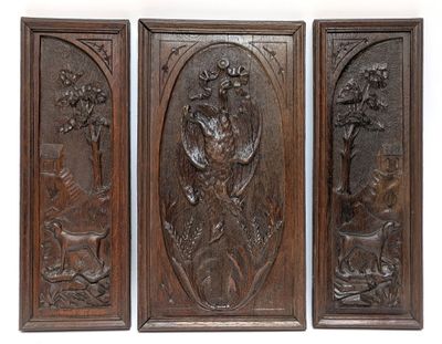 three wooden panels with carvings of animals and flowers on them