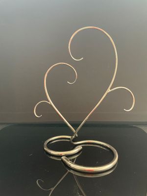 une sculpture métallique représentant une paire de ciseaux posée sur une table