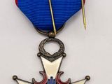 the medal is attached to a blue ribbon with red and white stars