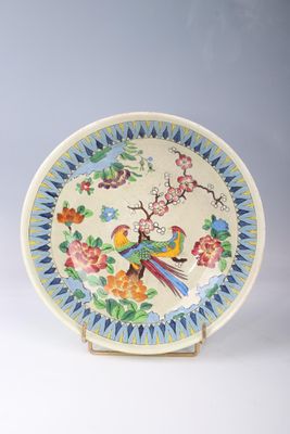 a plate with a bird and flowers on it