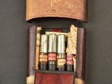 a leather case with lipstick in it on a table