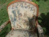 a chair that has a tapestry on it in the grass
