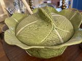 a cabbage bowl on a table with a lamp on it