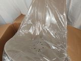 a plastic chair in a box wrapped in plastic