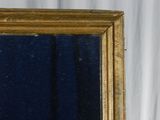 a mirror with a gold frame on a white background