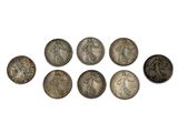 a group of six silver coins sitting on top of each other