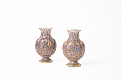 pair of vases sitting on a white surface with a white background