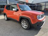 the red jeep is parked in front of a building