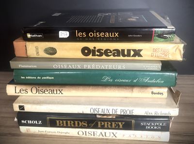 many books stacked on top of each other on a table