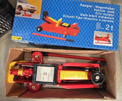 a box with a toy car in it on the floor