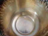 a close up view of a metal bowl with water in it