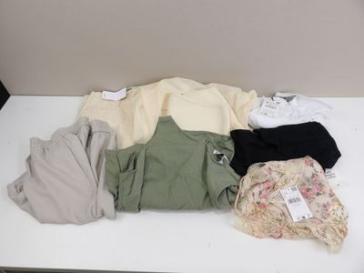 a lot of clothes that are on a white table