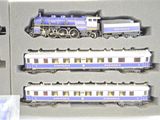 a box with three different model trains in it