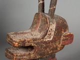 an image of a wooden sculpture of a dog ' s head with two horns