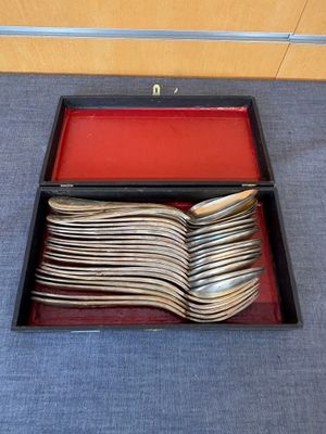 beaucoup de cuillères en argent dans une boîte rouge