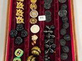 une boîte en bois remplie d'un assortiment de boutons et d'autres objets