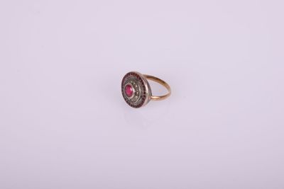 Gros plan sur une bague contenant une pierre rouge