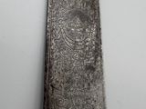 a large metal object on a shelf next to a wall