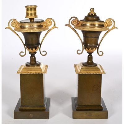 pair of antique brass vases on pedestals on white background