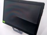 a tablet computer sitting on a stand on a table