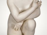 an image of a statue of a boy sitting on a rock