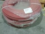 a roll of red wire wrapped in plastic on the floor