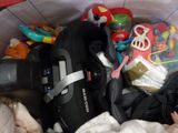 a baby in a stroller filled with toys