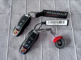 three car keys and a keychain on a bed