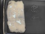 a black tray with a piece of cloth on top of it
